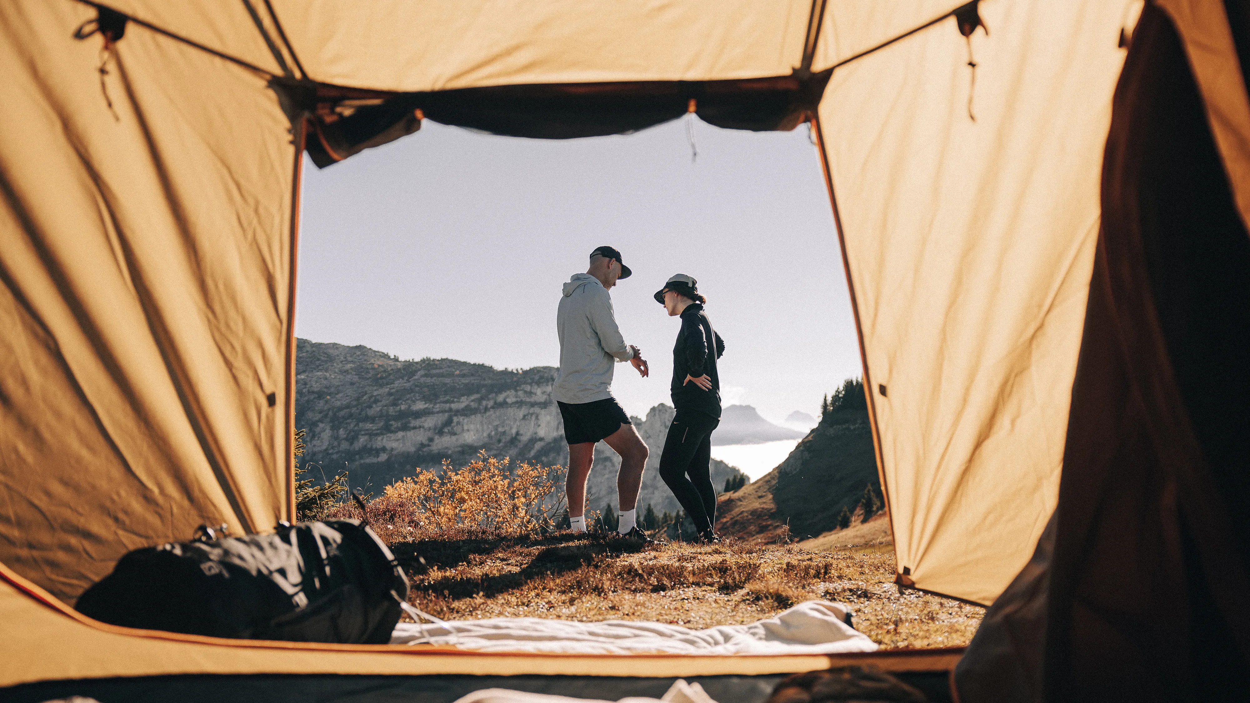 A couple standing outside a Kampa tent awning
