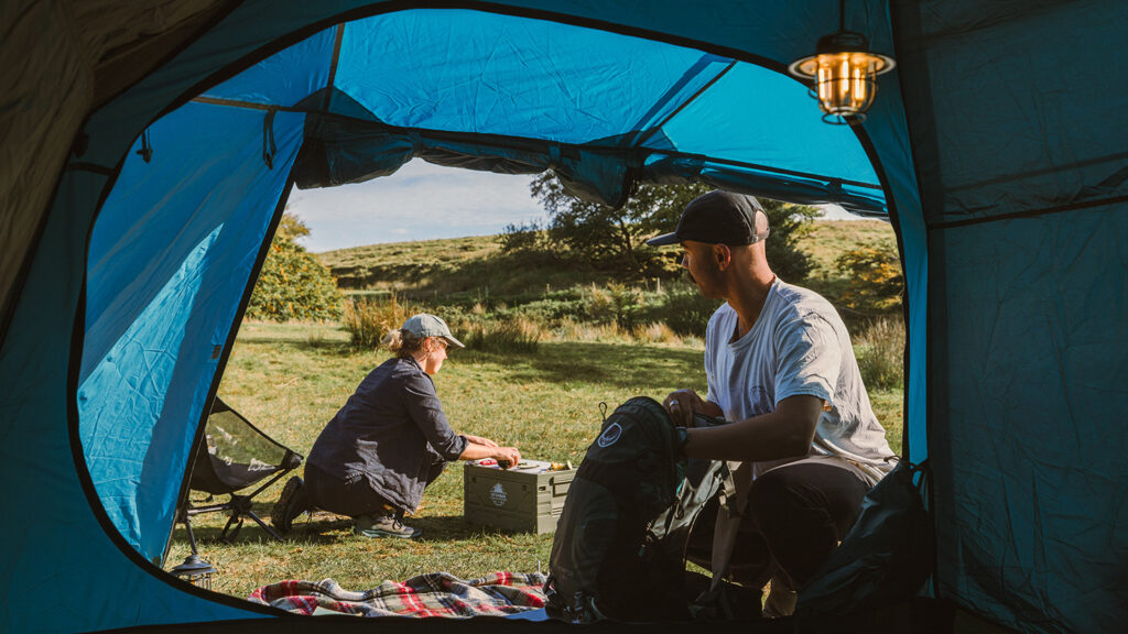 A couple setting up their Kampa tent for a camping trip